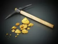 mining-pickaxe-and-gold-nuggets-standing-on-black-background
