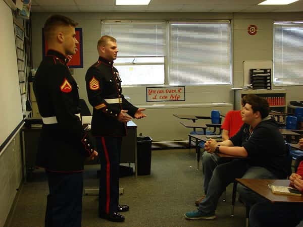 Lance Corporal Noah Willett and Staff Sergeant Michael Podzius, US Marines, with student Jacob Haney