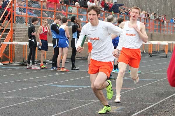 Dax Parker receives the baton from Collin Gunn earlier this season in the 4 x 800 relay.