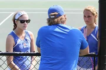 Hannah Travis (left) and Nikki Fehrenbacher discuss strategies with Coach Tyler during their match against Bowland and Zetter from Mayfield.