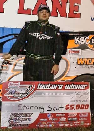 Stormy Scott poses with symbolic $5,000 check in victory lane.