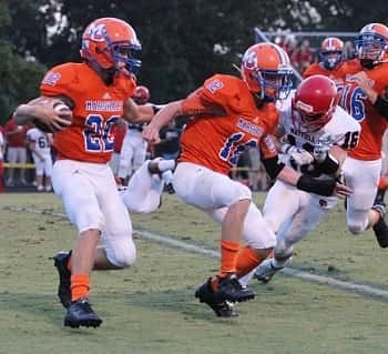 Collin Gunn (12) leads the way for Mason Green (22) during a punt return against Mayfield.