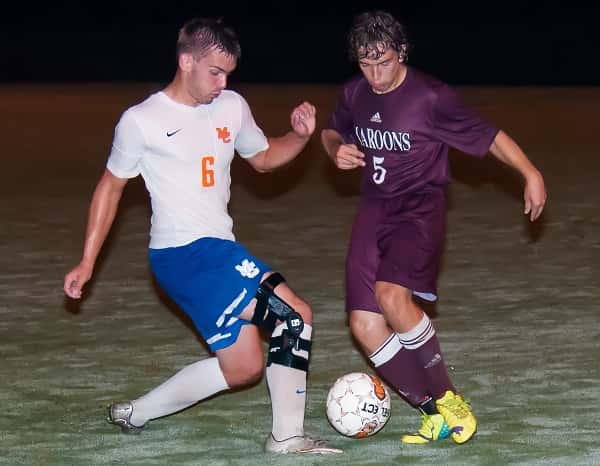 Dawson Jolley and Madisonville's Eric Baldwin battle for control of the ball. Photo by Bill Murphy at billmurphyphotography.com.