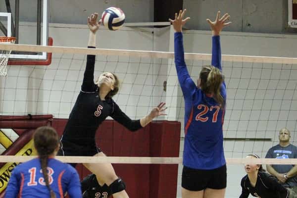 Great play at the net by CFS senior Emily Nelson (5) getting this hit past Hannah Langhi (27).
