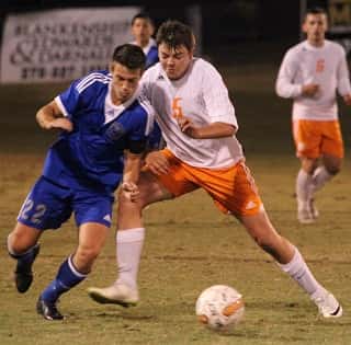 Tucker Lovett worked to keep the ball away from Graves County's Brady Wetherington.