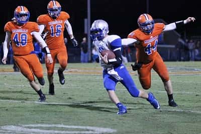 Jacob Mason (44) grabbed the jersey of Graves County QB Ryan Mathis to bring him down.
