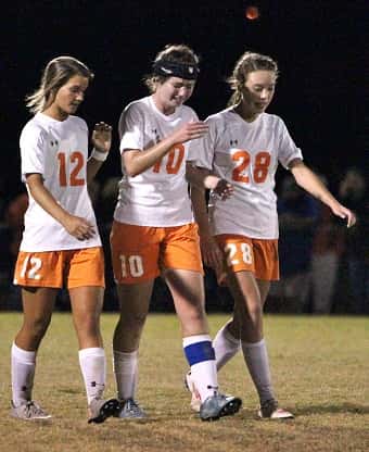 Senior Rachel McWilliam (center) is consoled by teammates senior Mackenzie Harper (left) and Bailie Wood following their loss.