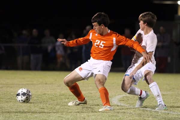 Luke Janiec blocks Calloway's Christian Adams from the ball in Wednesday's district tournament semi-final game.