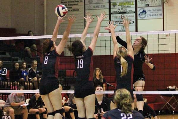 Emily Nelson was met at the net by three McCracken County blockers, Cate Hyde (8), Courtney Griffith (19) and Madeline Wooten (11).