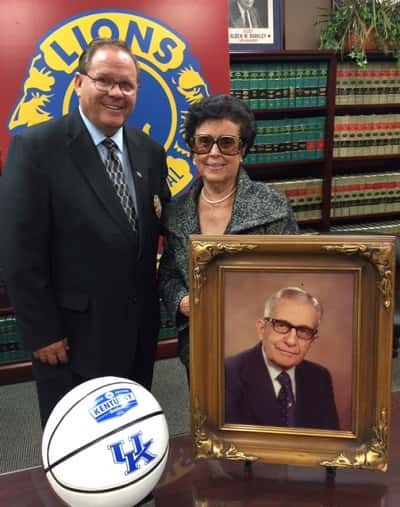 Local Pastor Richard P. Beck, chairperson of this year's WPSD Local 6-Area Lions Clubs Telethon "Celebration Concert," accepts a set of two third-row courtside tickets for a U.K. mens' basketball game at Rupp Arena in Lexington from Mrs. Marie Jackson. Jackson's tickets are one of six sets of lower arena tickets to be given away as door prizes to those in attendance at this year's reformatted four-hour televised telethon concert, and were donated in memory of her late husband, Dr. V.A. Jackson (pictured), who served as team physician under coaches Adolph Rupp and Joe B. Hall.