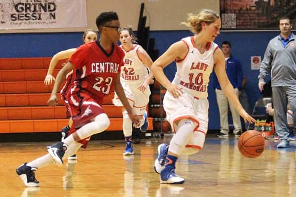 Nikki Fehrenbacher dribbling away from Hopkins County's Lyrie Campbell, scored 11 points for the Lady Marshals in their 54-49 win.
