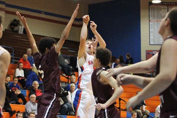 D.J. Pigg lets go of a 3-pointer, the first of three, in his 18 point game against Pope County.