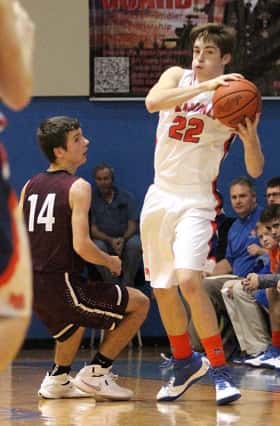 Skyler Smith with the ball for the Marshals, guarded by Pope County's Zach Fasolo.