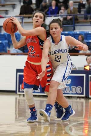 Tera Colson keeps the ball away from Tilghman's Sophia Patterson.