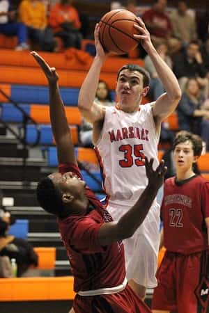 Aaron Reed got this shot off over McCracken County's Tyce Daniel.