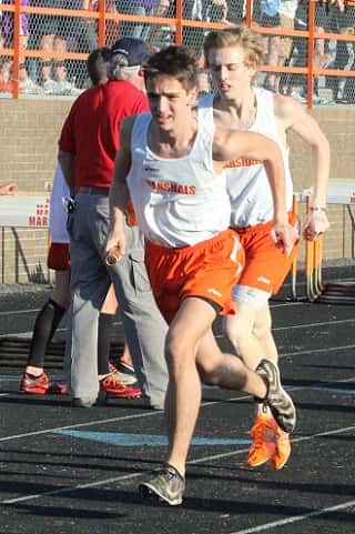 Jackson Yates takes the baton from Joseph Reed in the 2-mile relay.