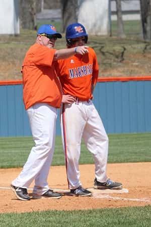 Head Coach Mike Johnson talks things over with Jackson Beal at 3rd base.