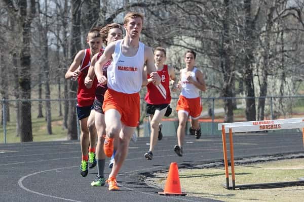 Collin Gunn rounds the curve in the first lap of the 1600 meter run in which he finished second behind Henry County's Javan Winders who missed setting a meet record by just over 1 second.
