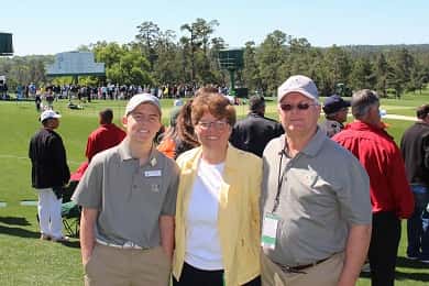 Jay and his parents, Annette and Ricky, in front of the 18th green at Augusta.