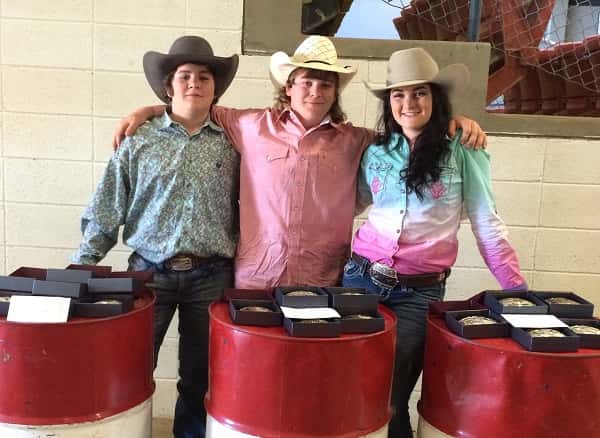 Kolton Powell, Rylen Sutherland and Josey Powell (L-R) with their buckles and gift cerficates for a custom Ammerman saddle for winning All Around Champions. 