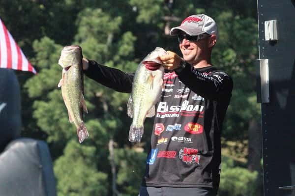 Pro bass angler, Brandon Hunter of Benton, shows off a couple of the fish from Sunday that earned him 2nd place in the Walmart FLW Tour on Kentucky Lake.