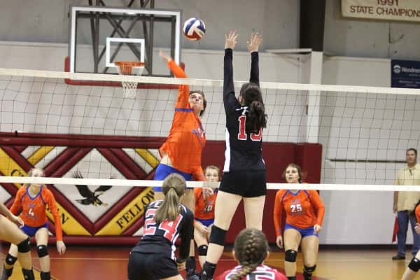 Hannah Langhi with the hit for the Lady Marshals over CFS blocker Sarah Muller.