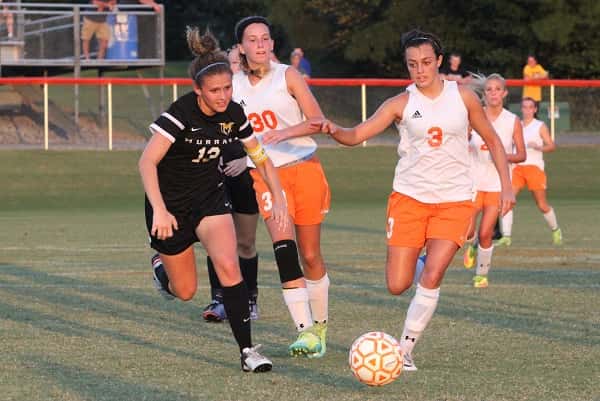 Kayla Travis gets to the ball ahead of Murray's Ann Taylor.