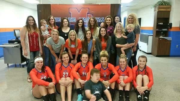 Former MCHS volleyball players got together for Alumni Night and took a picture with the Lady Marshal seniors before the game.