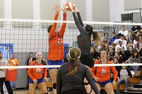 Marshall's Hannah Langhi and McCracken's Carsten Harned meet at the ball above the net in the Lady Marshals game last week against the Lady Mustangs.