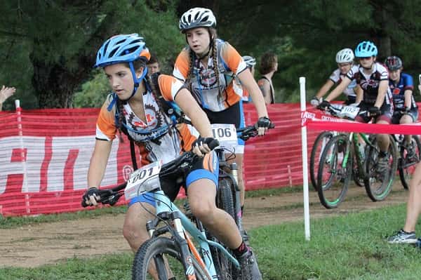 Audrey Grizzard and McKenzie Tack lead a group of Varsity and JV riders at the start of a recent race. The Marshall County Mountain Bike Team leads the team standings in the Tennessee Interscholastic Cycling League.