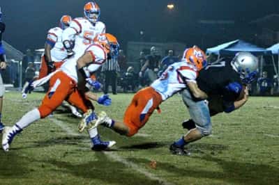 The Marshals Grant Johnson (15) wraps up Brennen Culp (7) in Friday's district game at Graves County.