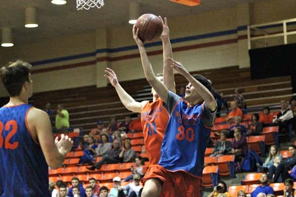 Dylan Walters (31) attempts to block the shot of Tristen Prange (30) in the Marshals scrimmage at Thursday's Meet the Marshals.