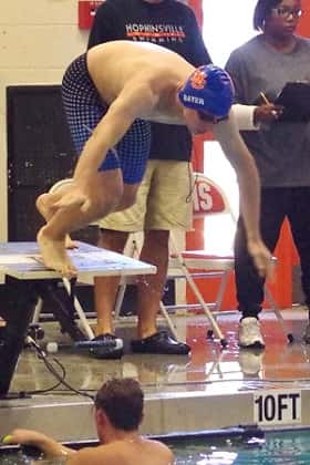 Isaac Bayer leaving the blocks during a relay event.