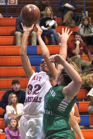 Leah Shelley (54) gets a hand up against Paige Henson (32) in Tuesday's season opener at Marshall County.