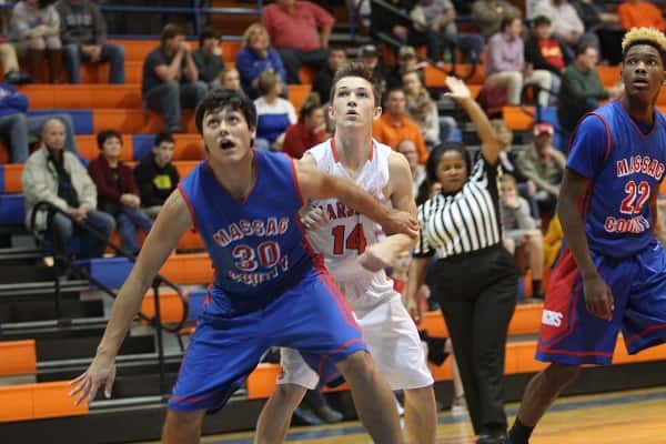 Lucas Nichols (14) blocked following a Marshall free throw by Massac's Andrew Rennie (30) in Thursday's opening night of the Marshall County Hoopfest.
