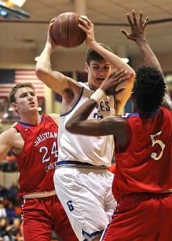 Chris Vogt is double teamed by Christian County's Kolbie Langhi (24) and Jayhvon Poindexter (5).