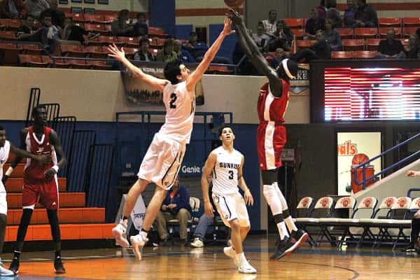 Matur Maker (5) shoots over the out-stretched hand of Juan Ignacio Ducasse (2).