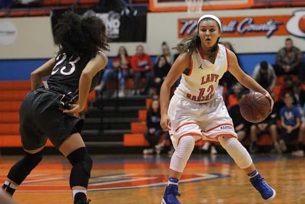 Sophomore guard Tera Colson (12) was matched in speed by Henderson County's senior guard Breanna Chester (23).