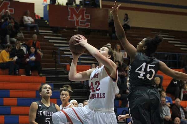 Hannah Langhi (42) got this shot off past Henderson's Alisha Owens (45).