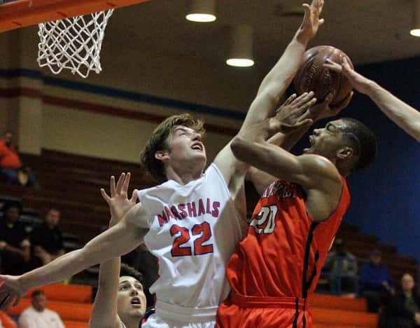 Skyler Smith (22) gets an arm up in the face of Hopkinsville's CJ Henagan (20) during the Marshall County game against Hopkinsville in Saturday's Hoopfest.