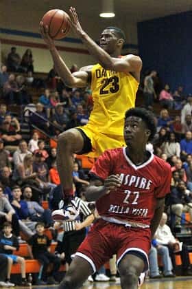 Oak Hill's Billy Preston (23) flies high towards the goal over Aspire player Joel Brown.