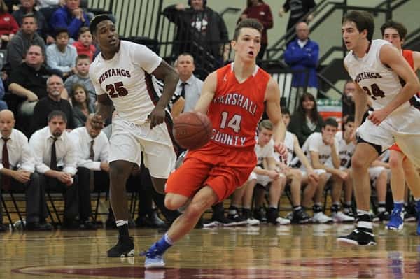 Lucas Nichols (14) bringing the ball down court for the Marshals in the closing minute of the win over the Mustangs.