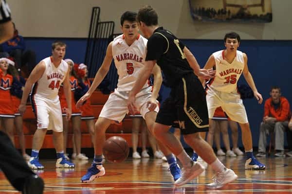 Tristen Prange (5), Houston Harvey (44) and Aaaron Reed (35) keep their eyes on Zach Flener with the ball for Murray.