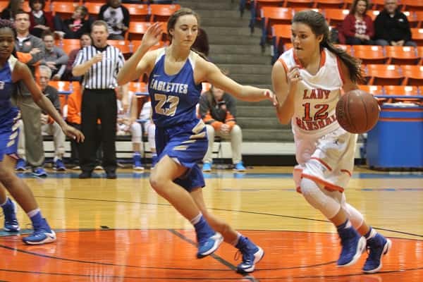 Marshall County's Tera Colson driving with the ball guarded closely by Jenna Holt (23).