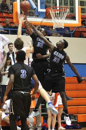 Dylan Walters was met by Cairo defenders Malachi Brown (31) and Jaman Brown (21).