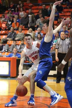 Aaron Reed works to get around Tilghman's Joe Workman Tuesday in the two teams first of two games this season.