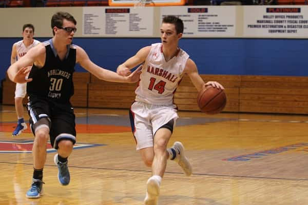 Lucas Nichols (14) bringing the ball down for the Marshals guarded by Muhlenberg's Ty Vincent.