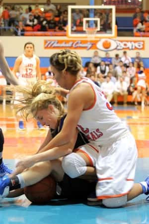 Paige Henson and Graves County's Lyndi Qualls scramble for the ball. Henson was back on the floor after a couple games out to rest an injury.