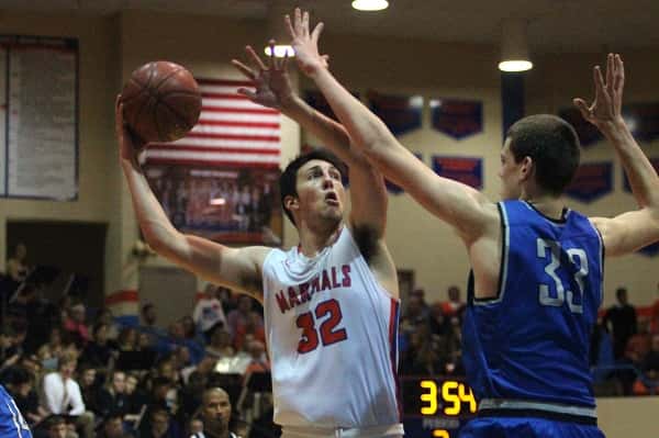 Matt French shoots over Graves County's 7'1" center Chris Vogt in Friday's homecoming game against the Eagles.