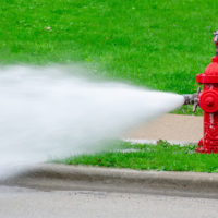 closeup-of-red-fire-hydrant-with-high-pressure-spray